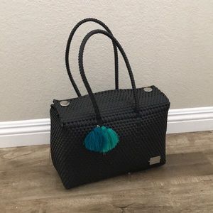 Black handwoven plastic market bag.